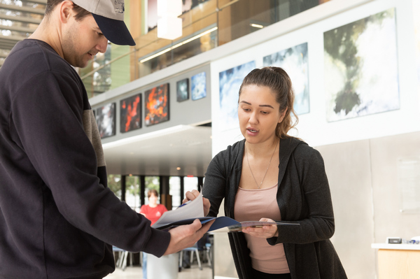 A BSU graduate admissions representative giving a student information