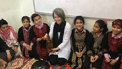 Christy Lyons sits with children in Jordan.