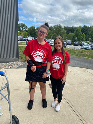 a BSU EXCEL student smiling and standing with her Ed Coach. Both are wearing matching red BSU t-shirts