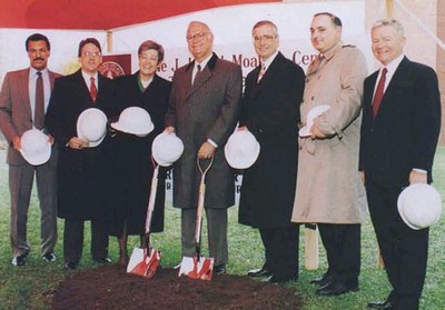 Congressman Moakley and other dignitaries hold shovels and hard hats at a groundbreaking.
