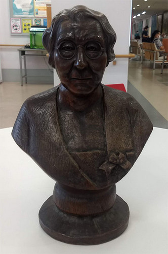 A bust of Adams sits on a table.