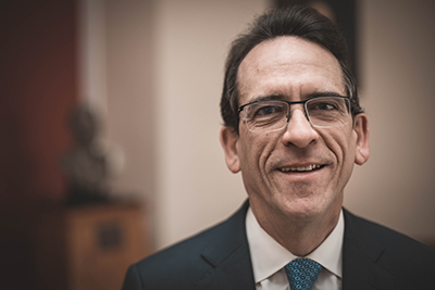 Headshot of Louis Ricciardi wearing a suit and tie