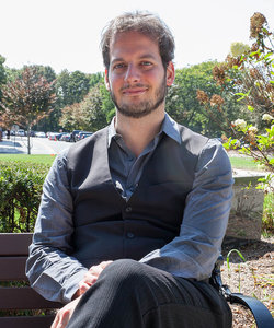 Alexandre Turgeon, Fall 2017 Killam Visiting Professor, sitting on a bench outside on a sunny day