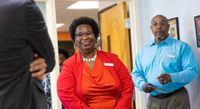 Two BSU employees meeting the new commissioner of higher ed; the employee in the center smiles brightly