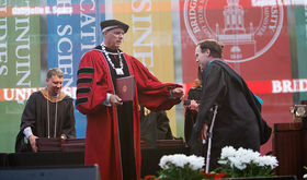 Brian Benson receives his graduate degree from BSU president Fred Clark at commencement