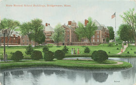 A postcard of Bridgewater State Normal School buildings, as seen from the campus pond. The building in the center is Normal Hall, erected in 1869. To the left are the old Tillinghast Hall and the old Woodward Hall.