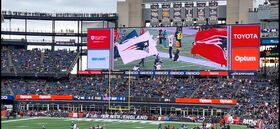 A person runs a flag on a football field