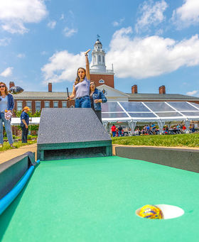 A BSU employee celebrates getting a mini-golf hole-in-one on the Boyden Quad