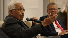 Pedro Pires speaks while holding a microphone.