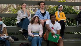 Five students sit on the benches in BSU's outdoor classroom