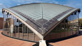 A photo of a v shaped building with a blue sky in the backgroun d