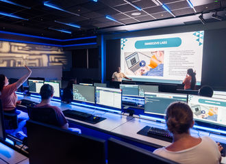 A student raises their hand in the BSU Cyber Lab