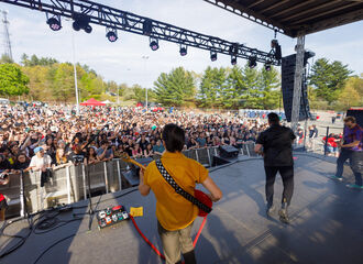 photo of Neon Trees concert on campus taken from behind the band onstage