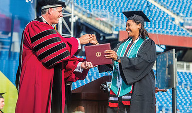 Fred Clark hands out a diploma