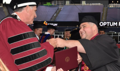 Benjamin Sangiolo receives his diploma from Fred Clark