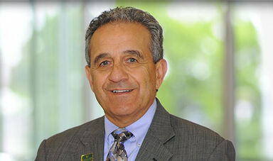 Headshot of Robert Antonucci standing in front of a corridor of windows.