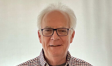 Headshot of Joe Burns in front of a white background.