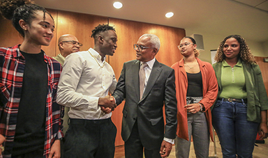 Cape Verde's president shakes hands with a BSU student as three other students look on.