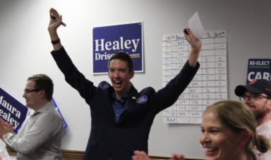 Evan Francis smiles with hands above his head