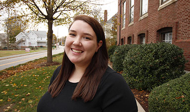 Portrait photo of Genna Symonds standing alongside Boyden Hall