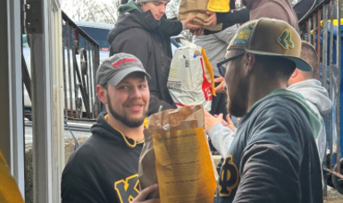 Members of Kappa Delta Phi deliver food to those in need