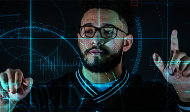 Omar Osman touches a clear screen with buttons and grid lines.