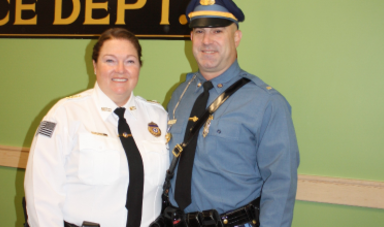 Patty Fisher stands next to a fellow police officer