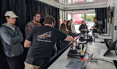 Students work with lab equipment in a mobile lab.