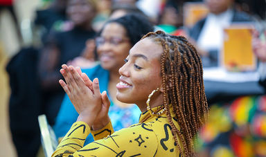 A closeup of a smiling student at the Black History Month event
