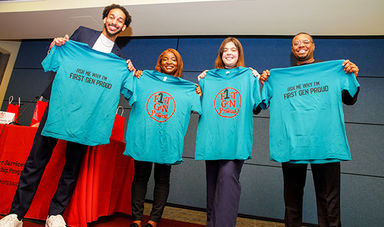 Four first generation BSU alumni smiling and holding up First Gen Proud t-shirts