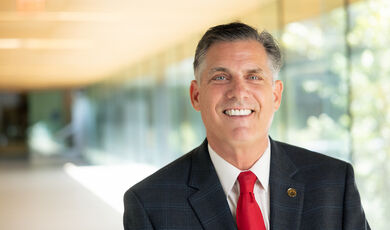 President Clark stands in a long hallway.