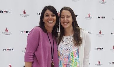 Merideth Kervosky and Mel Charmichael stand next to each other smiling 