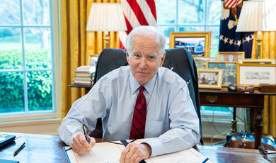 U.S. President Joe Biden singing a bill in the Oval Office