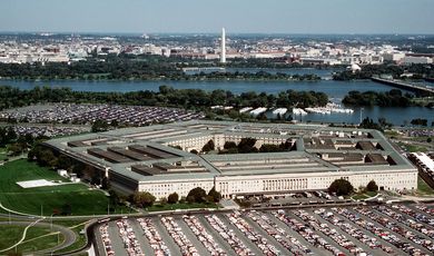 The Pentagon, looking northeast with the Potomac River and Washington Monument in the distance. The Tidal Basin is seen just below the Washington Monument. The marina which is visible is in Pentagon Lagoon, which is part of the Boundary Channel of the Potomac River. Trees border the Boundary Channel and exist both on the Virginia shoreline and on Columbia Island (an island in the Potomac River).