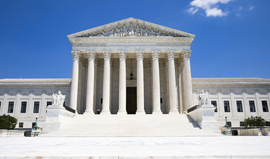 The front edifice of the Supreme Court of the United States building - a white, neoclassical building with pillars