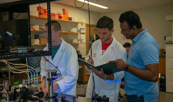 BSU Professor Thaya Paramanathan and 2 physics students work in the Single Molecule Lab