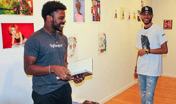 2 students smiling at an art exhibit at the BSU Anderson Gallery