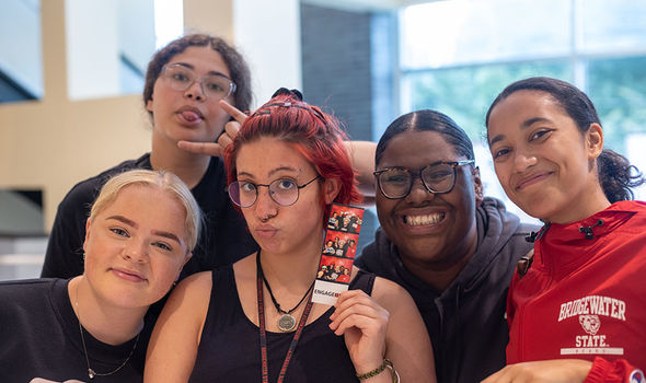 Five student leaders smile for the camera at the BSU involvement fair.