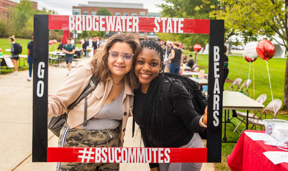 Two students in a frame that says &quot;Go Bears; Bridgewater State; #BSUCommutes&quot;