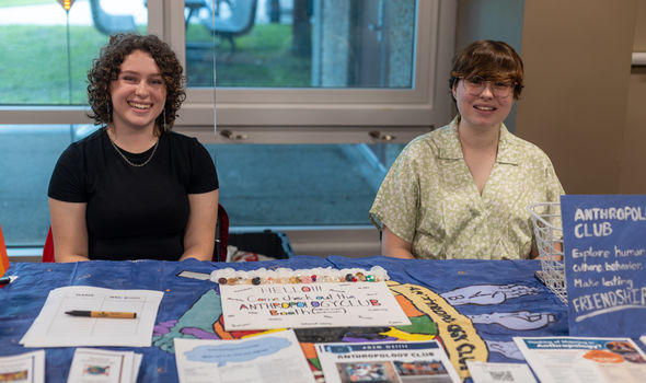 2 BSU students sitting behind an info table for the Anthropology Club at the Student Involvement Fair