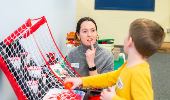 a BSU student working with a child in the Speech Language Literacy Center