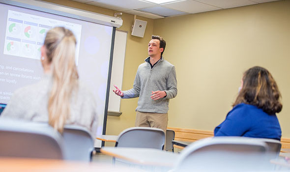 A public relations student gives a presentation during class