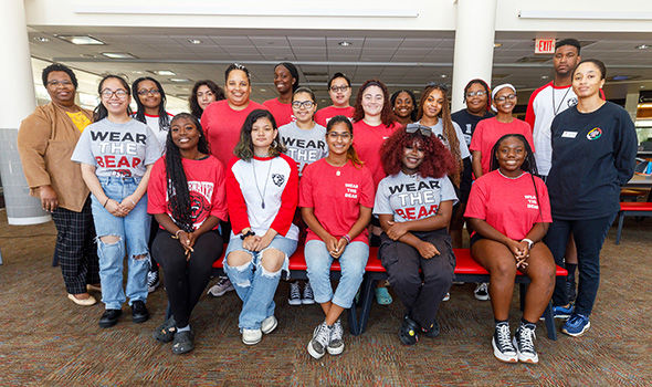 A group of students who participated in a LGCIE event, posing together and smiling for the camera