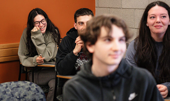 A classroom of PR students laughing and smiling