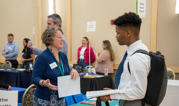 A BSU student speaks to a representative from Plimoth Patuxet Museums at BSU Job and Internship Fair