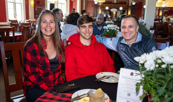 a BSU student with his parents at Homecoming Family Breakfast