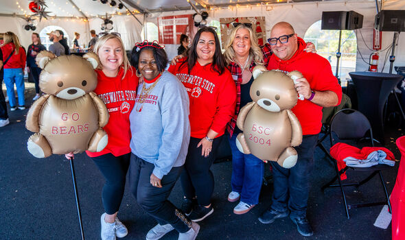 a group of BSU alumni in the Rathskellar Tent at Homecoming with specialized mylar bear balloons