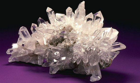 USDA Mineral Quartz Crystal is a spiky clear/white rock on a purple background
