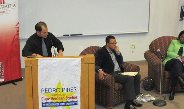 speaker at podium with 2 people seated beside it