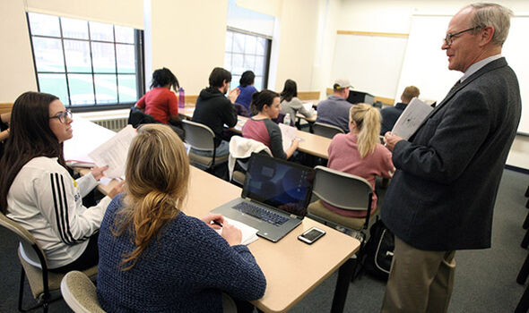 Professor Mark Crowley talking to a student during Accounting class